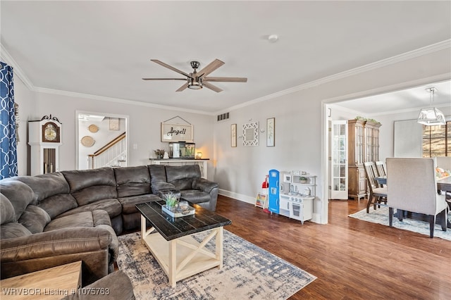 living room with hardwood / wood-style flooring, ceiling fan, and crown molding