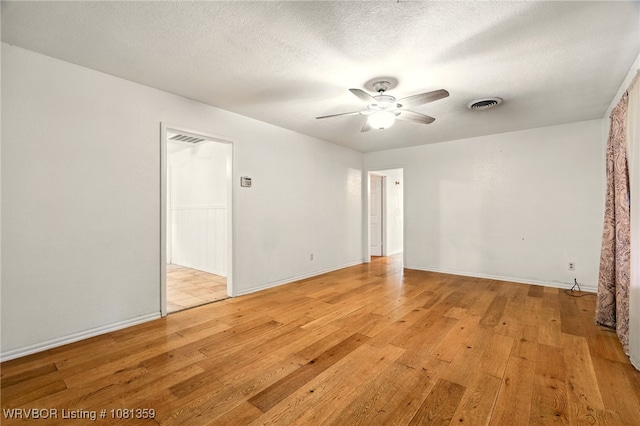 4002 57th St, Fort Smith, AR 72904 - empty room with light wood-style flooring, a ceiling fan, and a textured ceiling
