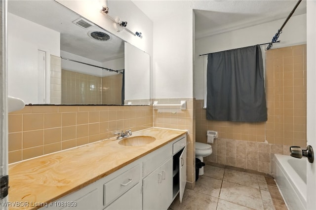 4002 57th St, Fort Smith, AR 72904 - bathroom with vanity, tile walls, washtub / shower combination, and tile patterned floors