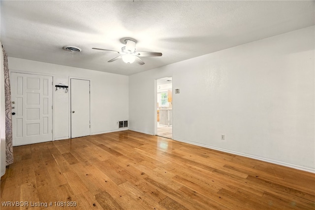 4002 57th St, Fort Smith, AR 72904 - empty room featuring light wood finished floors, a ceiling fan, and a textured ceiling