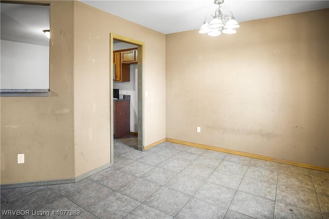 spare room with a chandelier