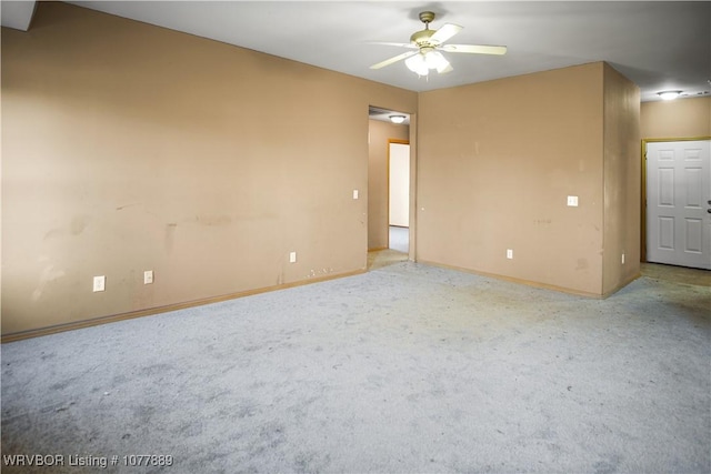 empty room featuring carpet floors and ceiling fan