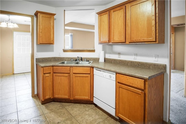 kitchen with white dishwasher, a notable chandelier, and sink