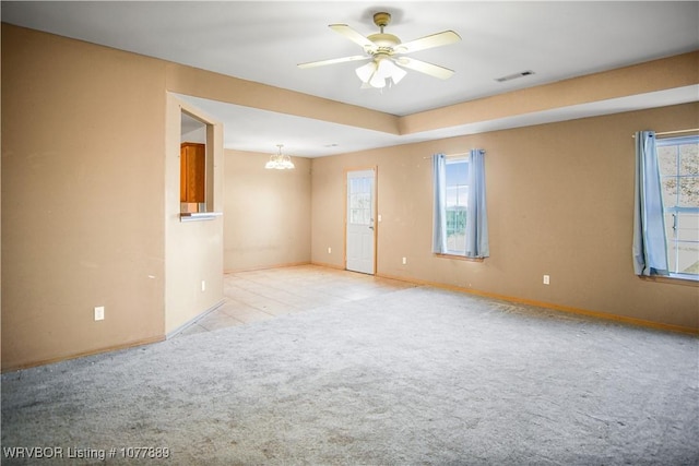 unfurnished room featuring light carpet and ceiling fan with notable chandelier