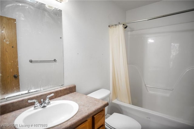 full bathroom featuring vanity, shower / bath combination with curtain, and toilet