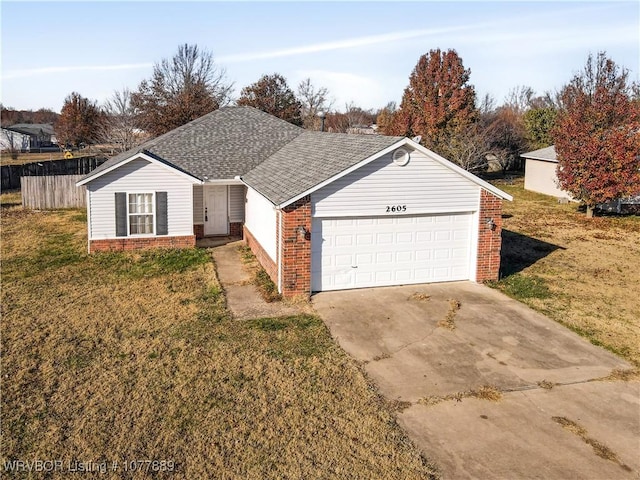 ranch-style house featuring a garage and a front lawn