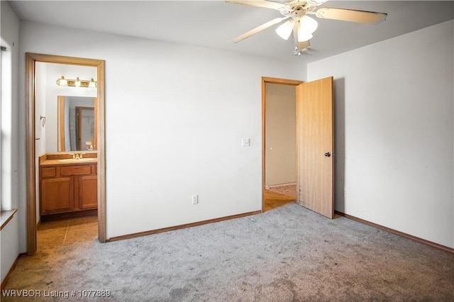 unfurnished bedroom featuring light carpet, connected bathroom, ceiling fan, and sink