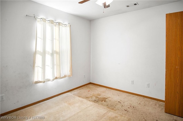 empty room featuring ceiling fan and carpet floors