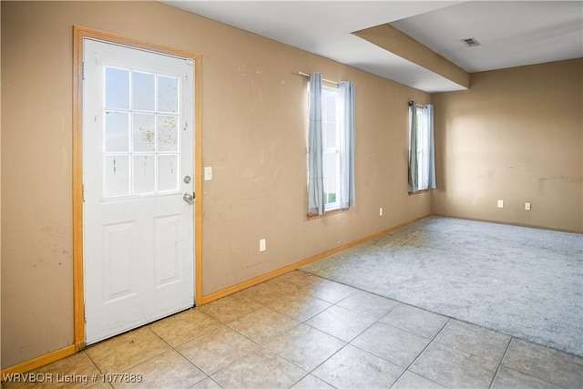 view of carpeted foyer entrance