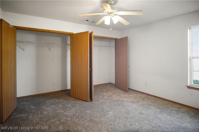 unfurnished bedroom with ceiling fan, a closet, and dark colored carpet