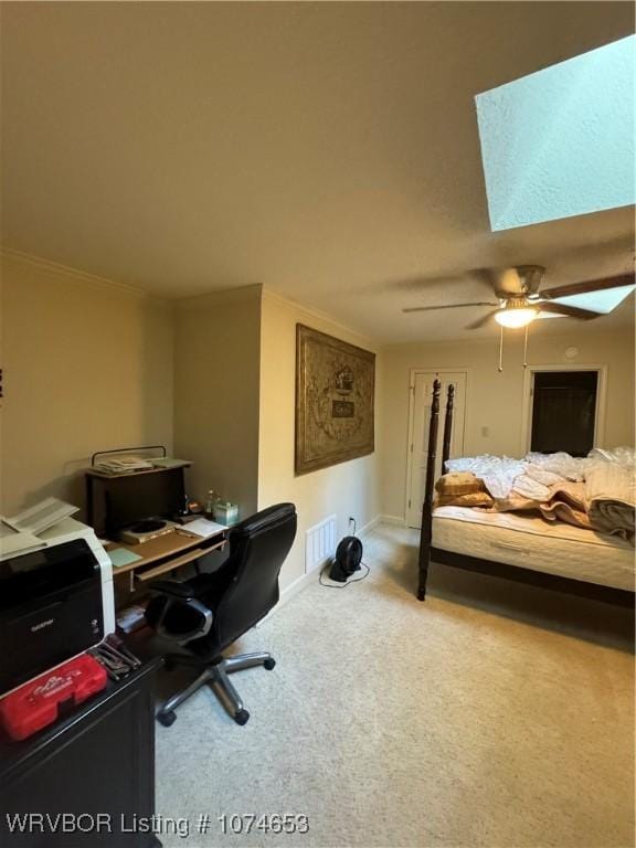 carpeted bedroom with ceiling fan and ornamental molding