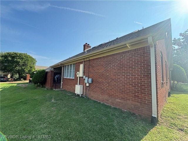 view of side of home featuring a lawn