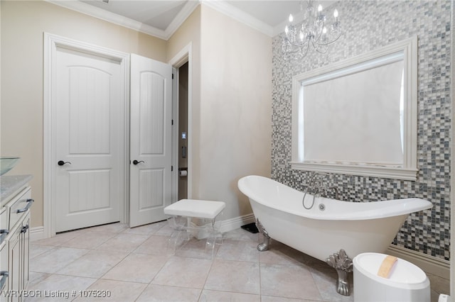 bathroom with vanity, ornamental molding, a tub to relax in, and a chandelier