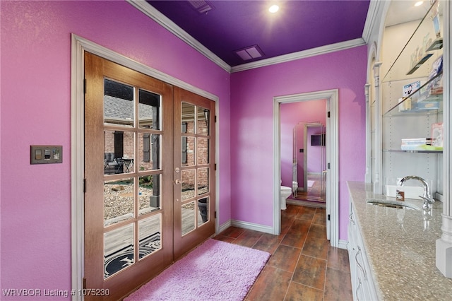 doorway to outside with french doors, ornamental molding, and sink