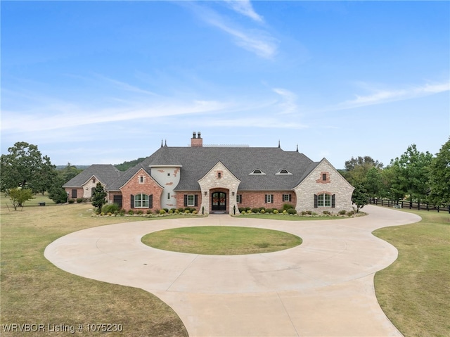 french country home with a front lawn