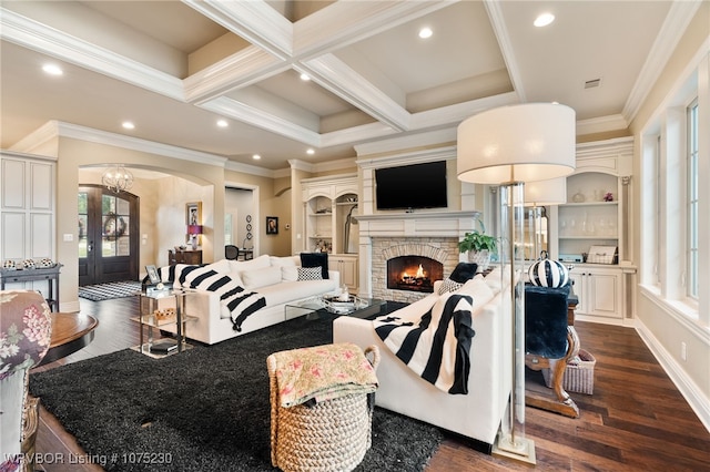 living room with coffered ceiling, a stone fireplace, beamed ceiling, dark hardwood / wood-style floors, and crown molding