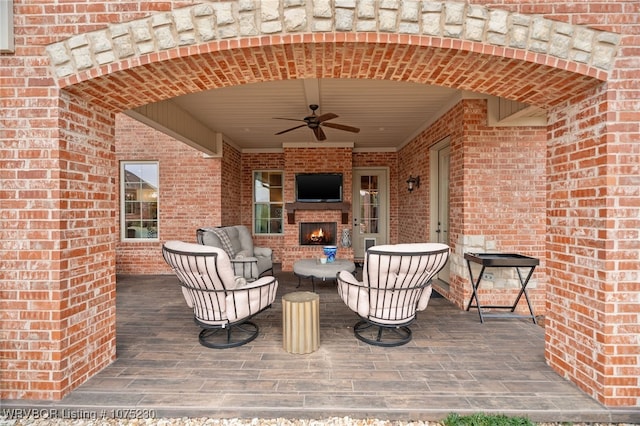 view of patio / terrace featuring an outdoor brick fireplace and ceiling fan