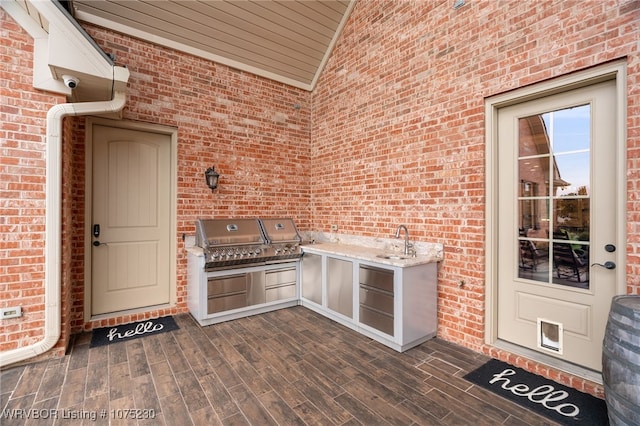 view of patio featuring sink, grilling area, and exterior kitchen