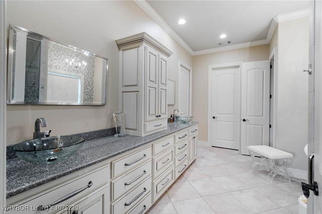 bathroom with crown molding, tile patterned flooring, and vanity