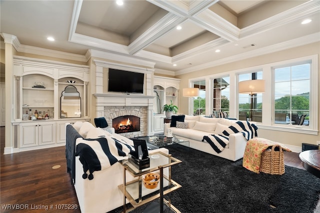 living room featuring a stone fireplace, dark hardwood / wood-style floors, coffered ceiling, and ornamental molding