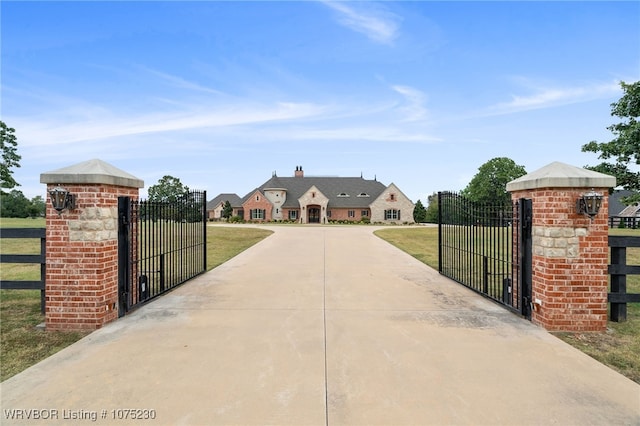 view of gate featuring a lawn