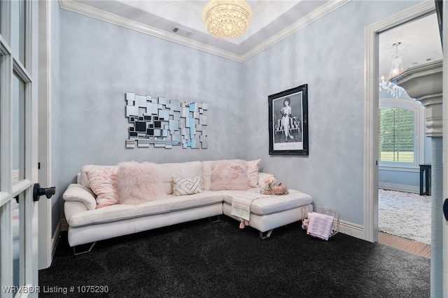 living room with crown molding and a notable chandelier