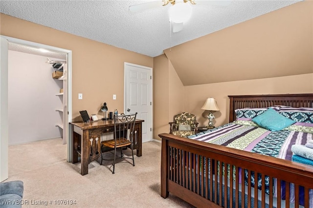 bedroom featuring a textured ceiling, light colored carpet, ceiling fan, and lofted ceiling