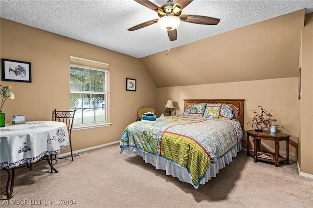 carpeted bedroom with a textured ceiling, ceiling fan, and lofted ceiling