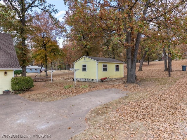 view of home's exterior with an outbuilding