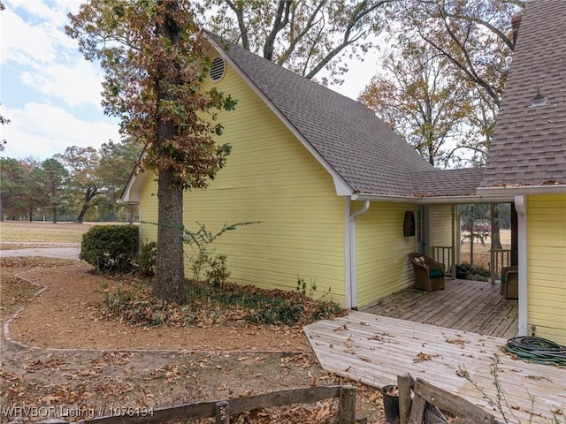 view of home's exterior with a wooden deck