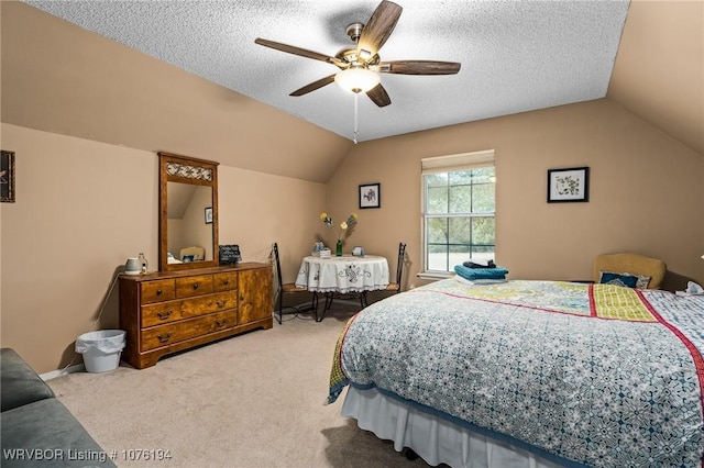 carpeted bedroom with a textured ceiling, ceiling fan, and lofted ceiling