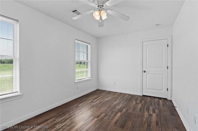 24401 Brazil Creek Loop, Shady Point, OK 74956 - spare room featuring baseboards, visible vents, ceiling fan, and dark wood-style flooring