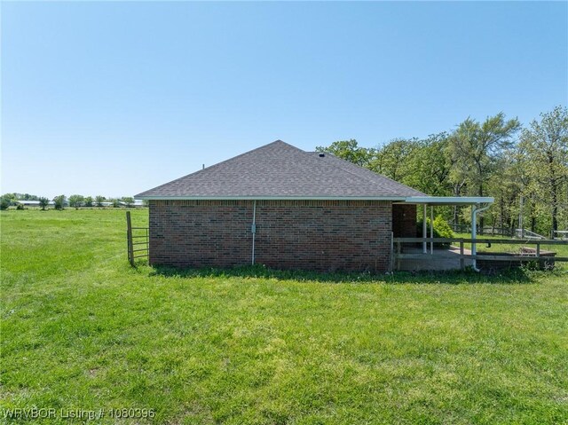 24401 Brazil Creek Loop, Shady Point, OK 74956 - view of home's exterior with fence, a lawn, brick siding, and roof with shingles