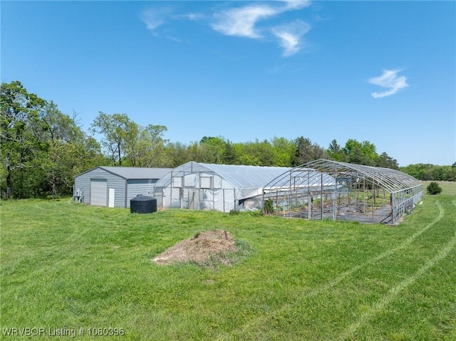 24401 Brazil Creek Loop, Shady Point, OK 74956 - view of greenhouse featuring a lawn