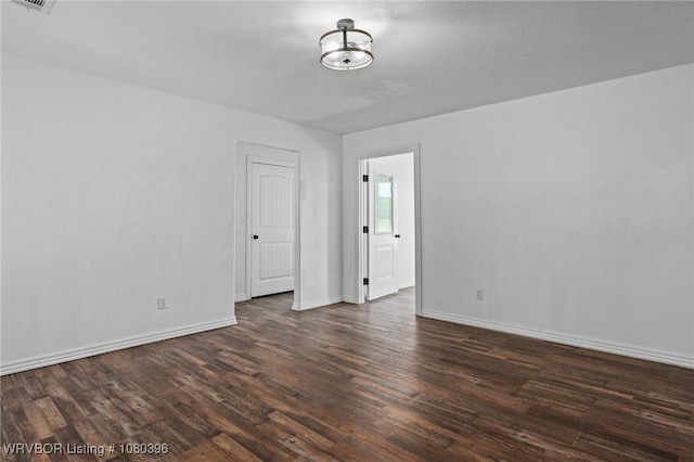 24401 Brazil Creek Loop, Shady Point, OK 74956 - unfurnished room with wood finished floors, visible vents, and baseboards