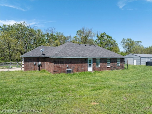 24401 Brazil Creek Loop, Shady Point, OK 74956 - rear view of house featuring fence, brick siding, a yard, and cooling unit