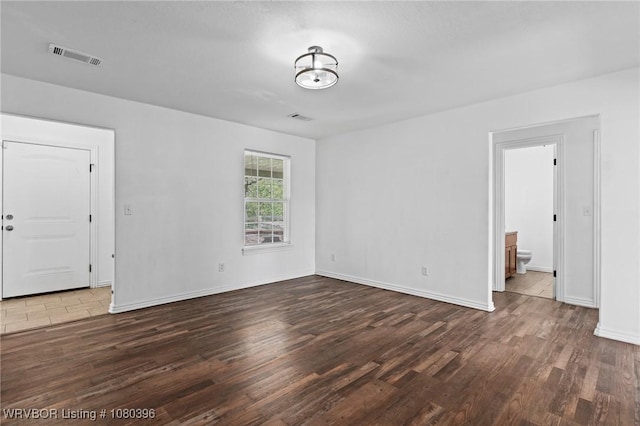 24401 Brazil Creek Loop, Shady Point, OK 74956 - empty room with visible vents, baseboards, and wood finished floors