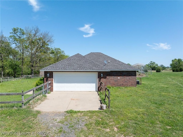 24401 Brazil Creek Loop, Shady Point, OK 74956 - view of property exterior with concrete driveway, fence, brick siding, an attached garage, and a yard
