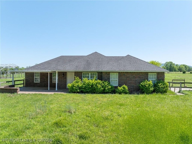 24401 Brazil Creek Loop, Shady Point, OK 74956 - view of front of home with brick siding, a patio area, a front yard, and fence