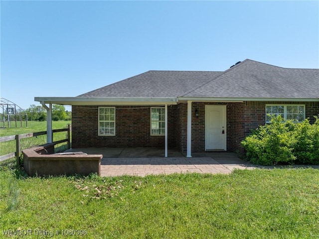 24401 Brazil Creek Loop, Shady Point, OK 74956 - exterior space featuring brick siding, a patio area, a lawn, and fence