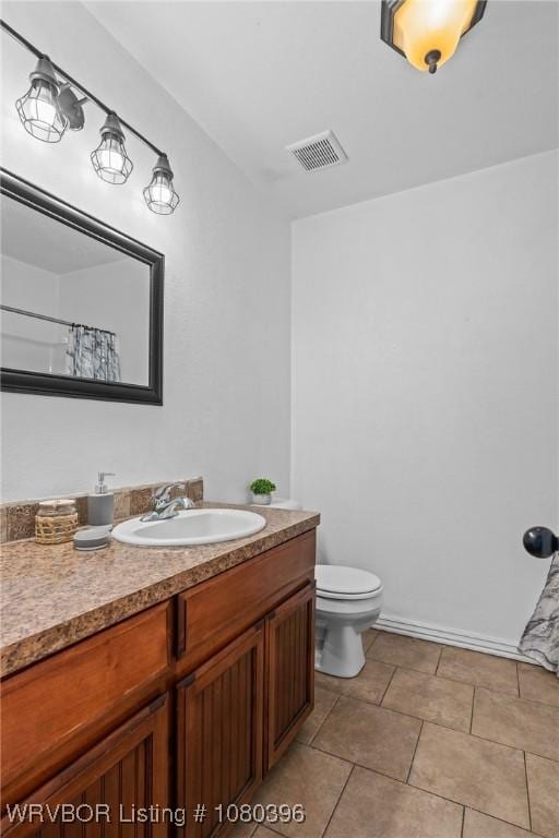 24401 Brazil Creek Loop, Shady Point, OK 74956 - bathroom featuring visible vents, vanity, and toilet