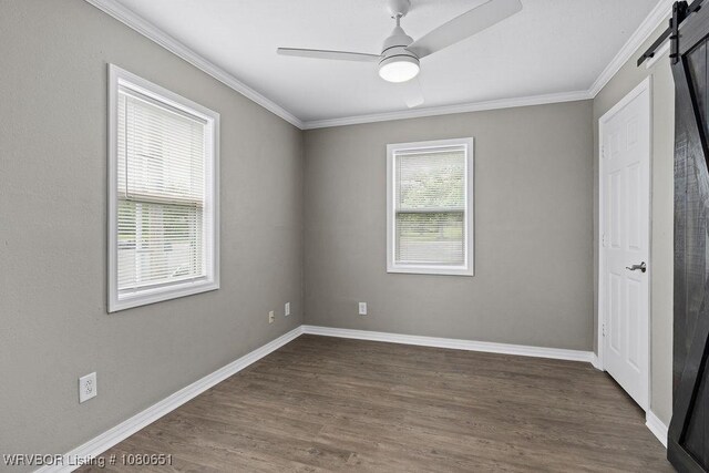 11 N 13th St, Van Buren, AR 72956 - unfurnished bedroom with dark wood-style floors, a barn door, and ornamental molding