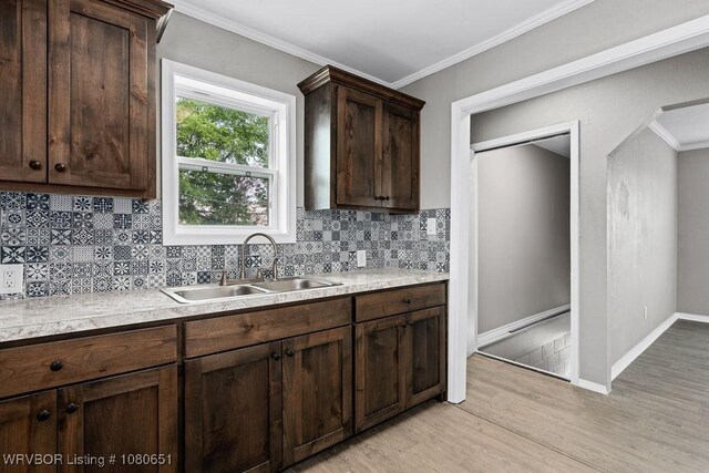 11 N 13th St, Van Buren, AR 72956 - kitchen with a sink, light countertops, decorative backsplash, and light wood-style flooring