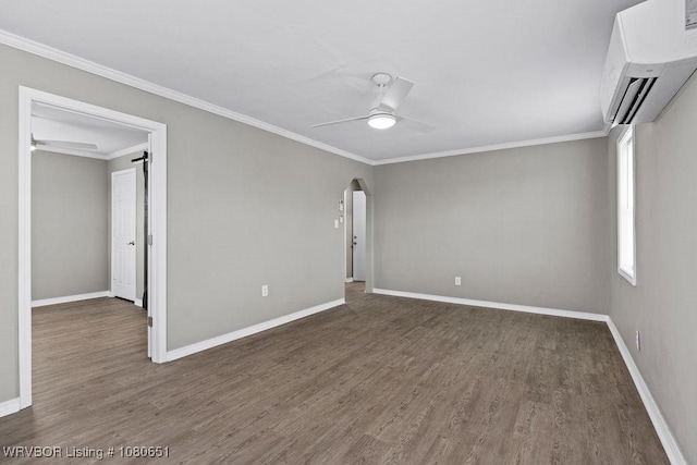11 N 13th St, Van Buren, AR 72956 - empty room featuring ceiling fan, a wall mounted AC, ornamental molding, and wood finished floors