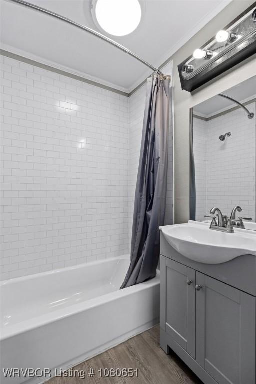 11 N 13th St, Van Buren, AR 72956 - bathroom with crown molding, vanity, shower / bath combo with shower curtain, and wood finished floors