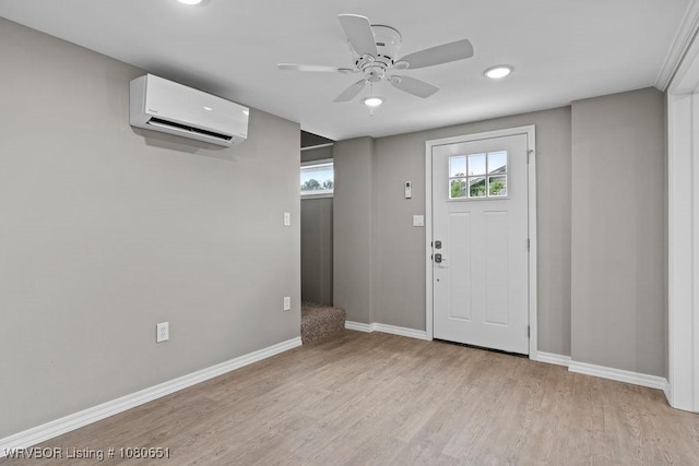 11 N 13th St, Van Buren, AR 72956 - entrance foyer featuring baseboards, a wall mounted AC, ceiling fan, and light wood finished floors