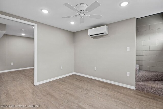 11 N 13th St, Van Buren, AR 72956 - basement featuring light wood-style floors, baseboards, ceiling fan, an AC wall unit, and recessed lighting