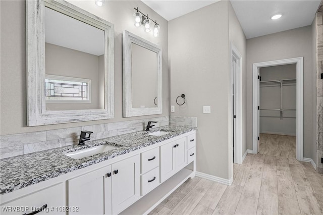 9505 Harmony Ridge Rd, Fort Smith, AR 72916 - full bathroom featuring double vanity, a spacious closet, and wood finished floors