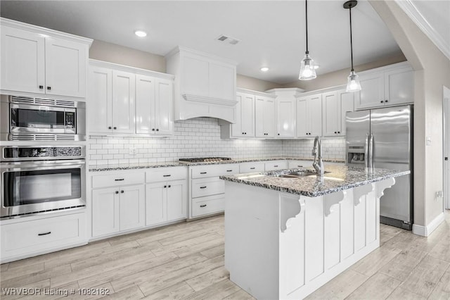 9505 Harmony Ridge Rd, Fort Smith, AR 72916 - kitchen featuring appliances with stainless steel finishes, white cabinets, light wood-style flooring, light stone countertops, and recessed lighting