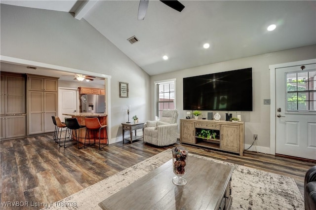 living area with baseboards, a ceiling fan, a healthy amount of sunlight, and dark wood-style floors